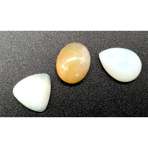 673 - A 6.80ct Ethiopian Multicolour Fire Opal Lot. Including 3 pcs. Cabochon. Pear & Oval Mixed. 2 whites... 