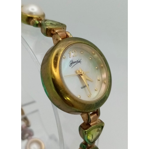 1153 - A Gems 925 Silver Quartz Ladies Watch. Pearl and peridot bracelet. MOP dial. In good condition and w... 