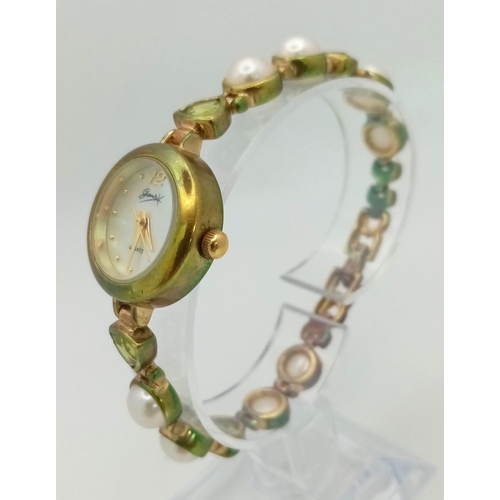 1153 - A Gems 925 Silver Quartz Ladies Watch. Pearl and peridot bracelet. MOP dial. In good condition and w... 