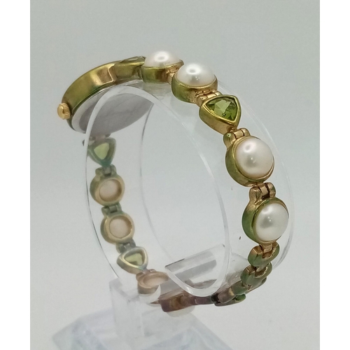 1153 - A Gems 925 Silver Quartz Ladies Watch. Pearl and peridot bracelet. MOP dial. In good condition and w... 