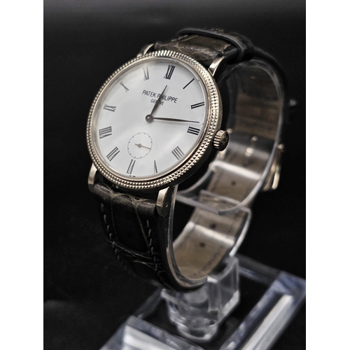 113 - An 18 K white gold Patek Philippe watch. 31 mmm case, white gold bezel, white face with Roman numera... 