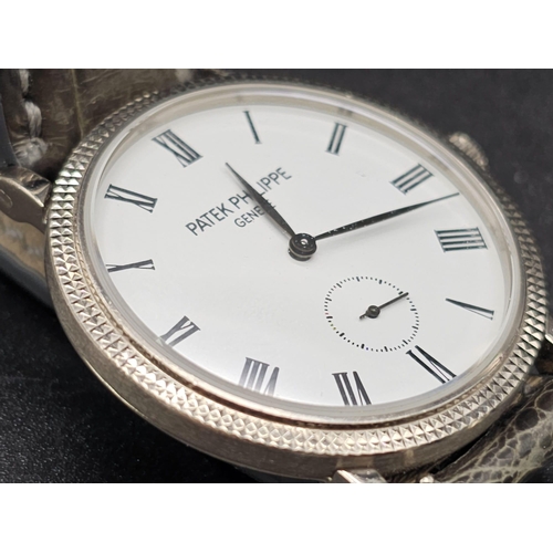 113 - An 18 K white gold Patek Philippe watch. 31 mmm case, white gold bezel, white face with Roman numera... 