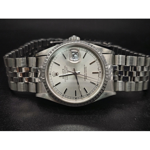 134 - A stainless steel ROLEX Oyster Perpetual Datejust watch. 36 mm case, silver tone face, hour marks an... 