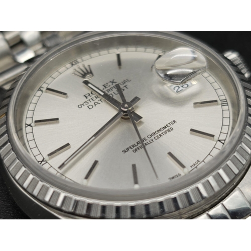 134 - A stainless steel ROLEX Oyster Perpetual Datejust watch. 36 mm case, silver tone face, hour marks an... 