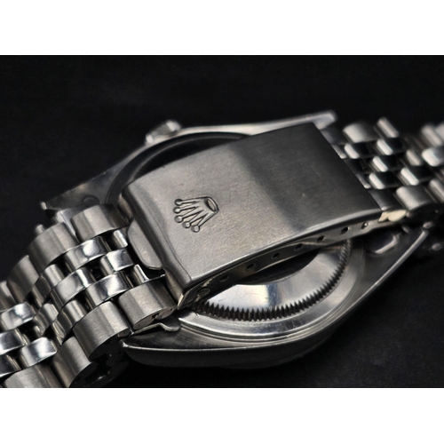 134 - A stainless steel ROLEX Oyster Perpetual Datejust watch. 36 mm case, silver tone face, hour marks an... 