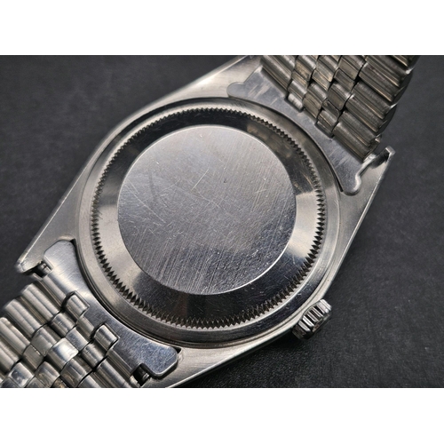 134 - A stainless steel ROLEX Oyster Perpetual Datejust watch. 36 mm case, silver tone face, hour marks an... 