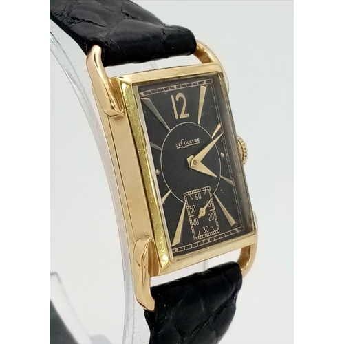 22 - A 14 K yellow gold Le Coultre watch. 27 x 20 mm case, gold bezel, black face with gold hour marks an... 