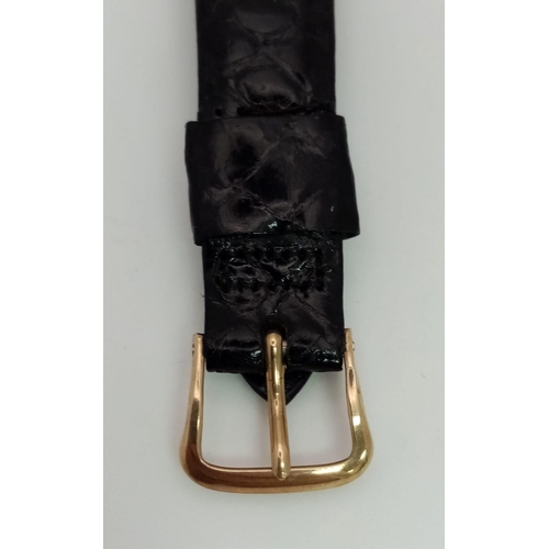 22 - A 14 K yellow gold Le Coultre watch. 27 x 20 mm case, gold bezel, black face with gold hour marks an... 