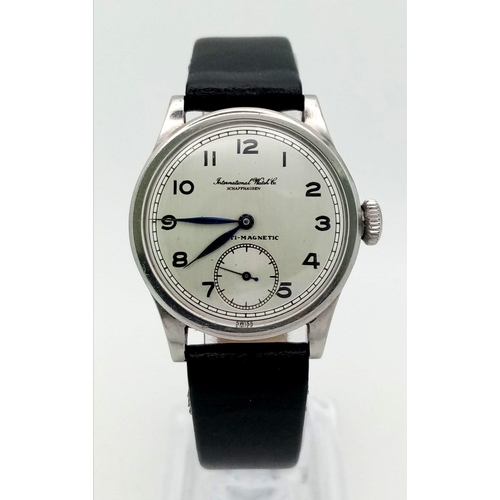 245 - An IWC watch. 30 mm case, white metal bezel, white dial with Arabic numerals. Antimagnetic manual mo... 