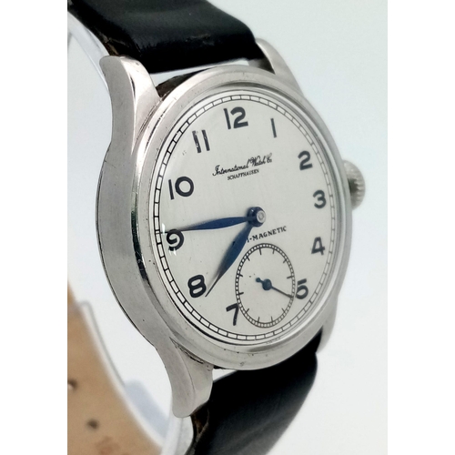 245 - An IWC watch. 30 mm case, white metal bezel, white dial with Arabic numerals. Antimagnetic manual mo... 