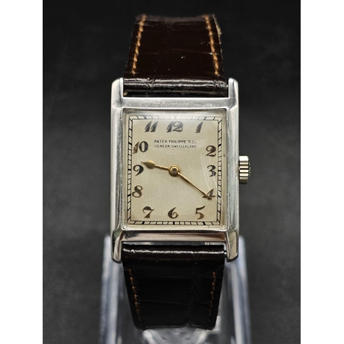 275 - A vintage Patek Philippe & Co watch. 27 x 23 mm white metal case, cream coloured face with roman num... 