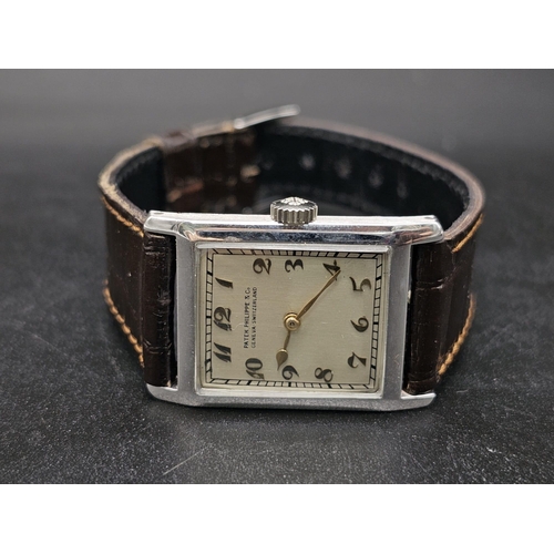 275 - A vintage Patek Philippe & Co watch. 27 x 23 mm white metal case, cream coloured face with roman num... 