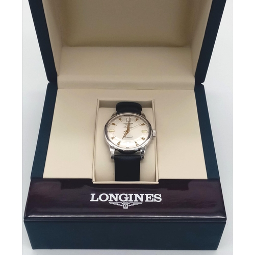 28 - A Longines Conquest watch. 35 mm case with white metal bezel, cream coloured face with yellow gold c... 