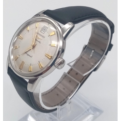 28 - A Longines Conquest watch. 35 mm case with white metal bezel, cream coloured face with yellow gold c... 