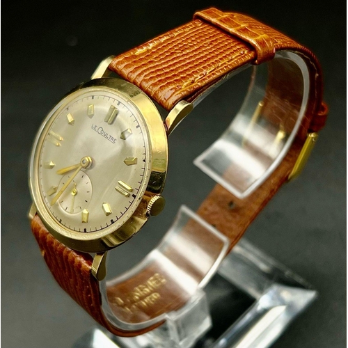 289 - A gold tone Le Coultre watch. Case with 33 mm diameter, gold tone bezel, cream face with gold tone h... 