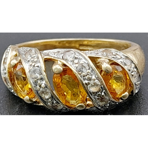 1285 - A Vintage 9K Yellow Gold Citrine and Diamond Ring. Three diagonal waves of bright citrine separated ... 