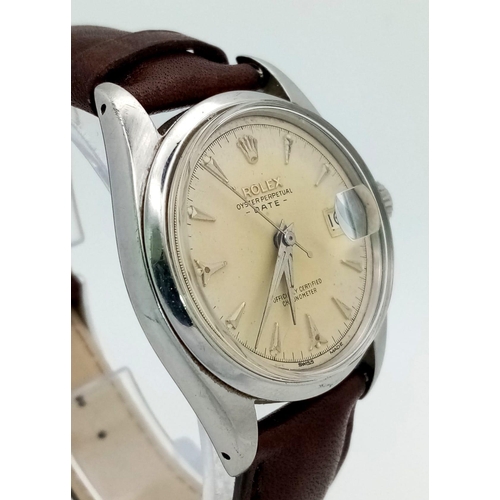 389 - A stainless steel ROLEX Oyster Perpetual Date watch. 34 mm case, steel bezel, cream coloured face, a... 