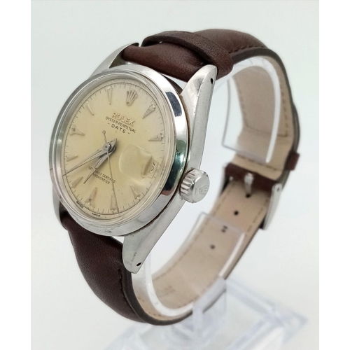 389 - A stainless steel ROLEX Oyster Perpetual Date watch. 34 mm case, steel bezel, cream coloured face, a... 