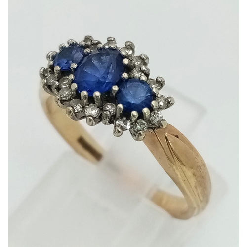 453 - A Vintage 9K Yellow Gold Sapphire and Diamond Ring. Three sapphires with a diamond surround. Size N.... 