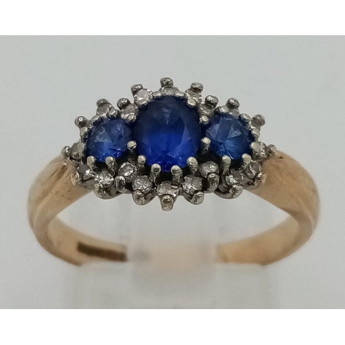 453 - A Vintage 9K Yellow Gold Sapphire and Diamond Ring. Three sapphires with a diamond surround. Size N.... 