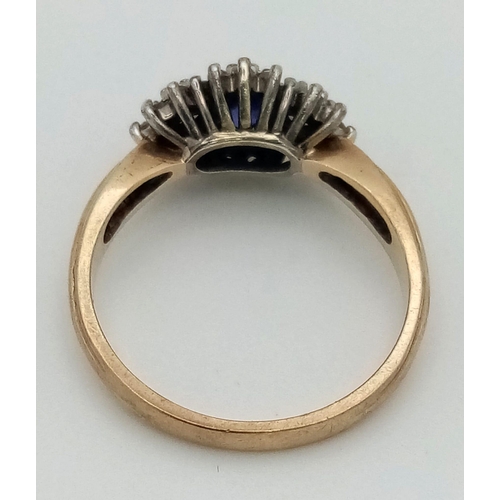 453 - A Vintage 9K Yellow Gold Sapphire and Diamond Ring. Three sapphires with a diamond surround. Size N.... 