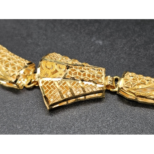 49 - A parure set of 21 K yellow gold, wonderfully hand crafted, probably made in India, consisting of a ... 