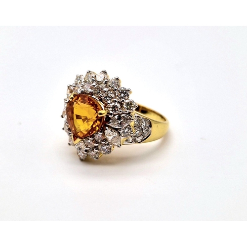 85 - Two 18 K yellow gold rings, one with an orange heart shaped sapphire surrounded with diamonds and th... 