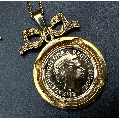 87 - A 22K Gold 2004 Half Sovereign set in a 9K Yellow Gold Diamond and Ruby Pendant on a 9K yellow gold ... 