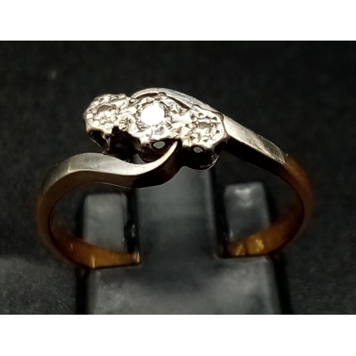 1770 - A Vintage 18K Gold and Platinum Three-Stone Diamond Ring. 
Size M 1/2. 2.42g total weight.