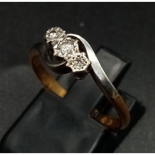 1770 - A Vintage 18K Gold and Platinum Three-Stone Diamond Ring. 
Size M 1/2. 2.42g total weight.