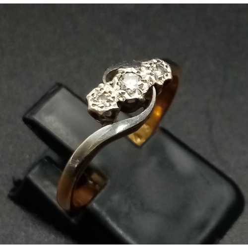 1770 - A Vintage 18K Gold and Platinum Three-Stone Diamond Ring. 
Size M 1/2. 2.42g total weight.