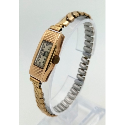 443 - A 9K Yellow Gold Antique Ladies Watch. Gold plated expandable strap. 9K gold case - 15 x 30mm. Mecha... 