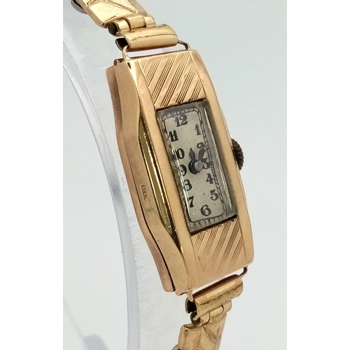 443 - A 9K Yellow Gold Antique Ladies Watch. Gold plated expandable strap. 9K gold case - 15 x 30mm. Mecha... 