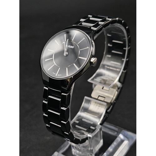 205 - A Rado True Thinline Black Steel and Ceramic Ladies Watch. Case - 30mm. Black dial. Quartz movement.... 