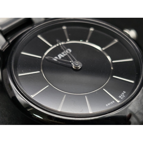 205 - A Rado True Thinline Black Steel and Ceramic Ladies Watch. Case - 30mm. Black dial. Quartz movement.... 