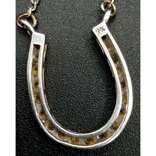 395 - A 9K White Gold Diamond Horse-Shoe Necklace. Perfect for the lady who loves her equine sports. 2cm a... 