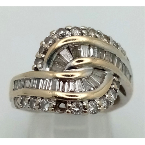 462 - An 18K White Gold Diamond Crossover Ring. Baguette and round cut diamond crossover. Note: one small ... 