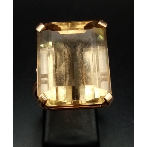 472 - A 9K Yellow Gold Lemon Quartz Ring. Large rectangular step cut 20ct stone. 9.7g total weight. Size O... 