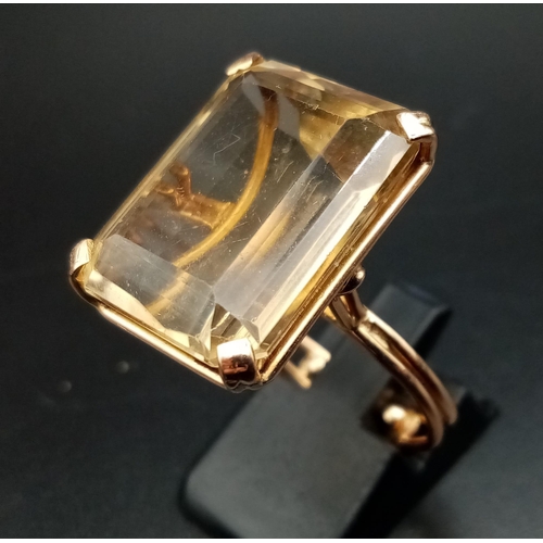 472 - A 9K Yellow Gold Lemon Quartz Ring. Large rectangular step cut 20ct stone. 9.7g total weight. Size O... 