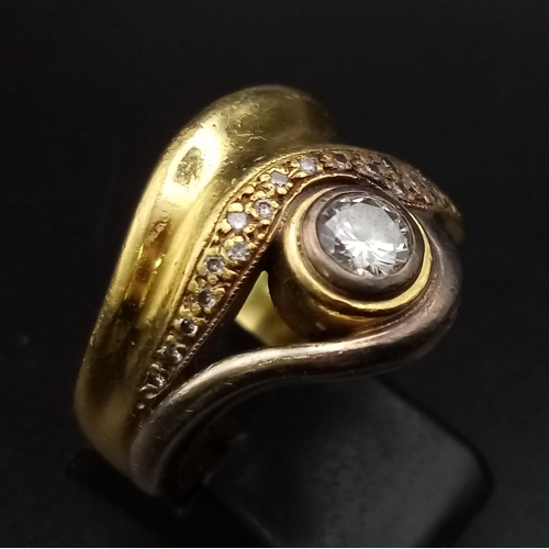 654 - A Vintage High-Karat Gold (tested) Diamond Swirl Ring. A 0.30ct diamond on a cluster wave of smaller... 