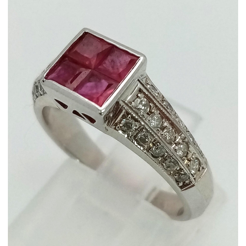 701 - An 18K White Gold Diamond and Ruby Ring. Four square-cut central rubies with a three row cluster of ... 