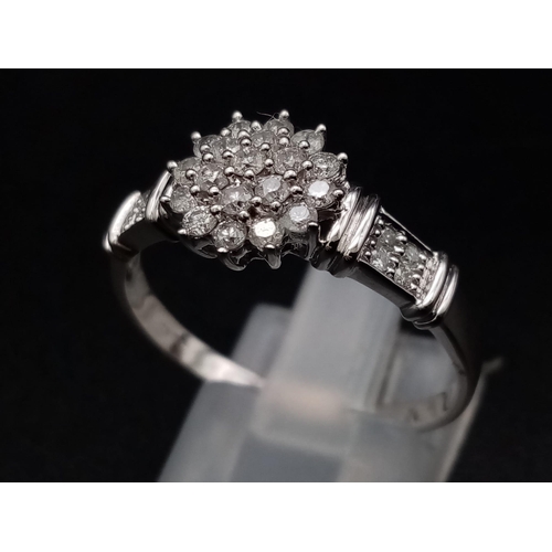 1056 - A 9K white gold ring with a cluster of diamonds and further diamonds on shoulders (diamonds 0.30 car... 