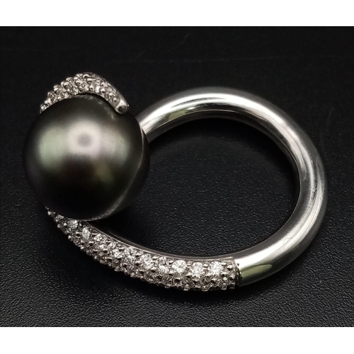 338 - An 18K White Gold, Diamond and Pearl-Swirl Ring. 0.94ct of wave encrusted diamonds create the perfec... 