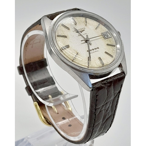 597 - A Vintage Longines Automatic Gents Watch. Brown leather strap. Case - 35mm. Discoloured dial with da... 