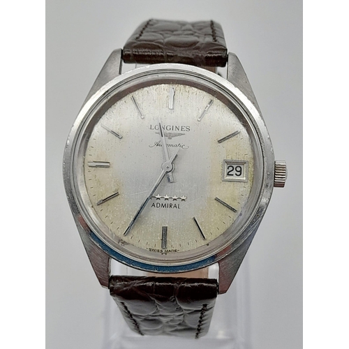 597 - A Vintage Longines Automatic Gents Watch. Brown leather strap. Case - 35mm. Discoloured dial with da... 