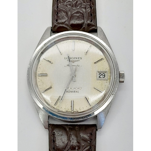 597 - A Vintage Longines Automatic Gents Watch. Brown leather strap. Case - 35mm. Discoloured dial with da... 