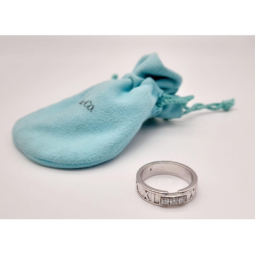 715 - A Tiffany and Co. 18K Atlas White Gold Diamond Trilogy Ring.
Three clean round cut diamonds with Rom... 