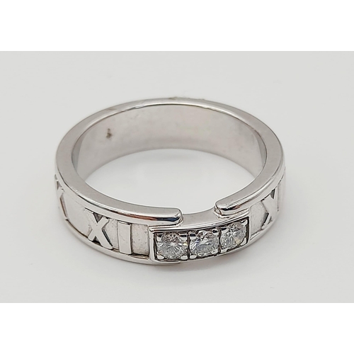 715 - A Tiffany and Co. 18K Atlas White Gold Diamond Trilogy Ring.
Three clean round cut diamonds with Rom... 