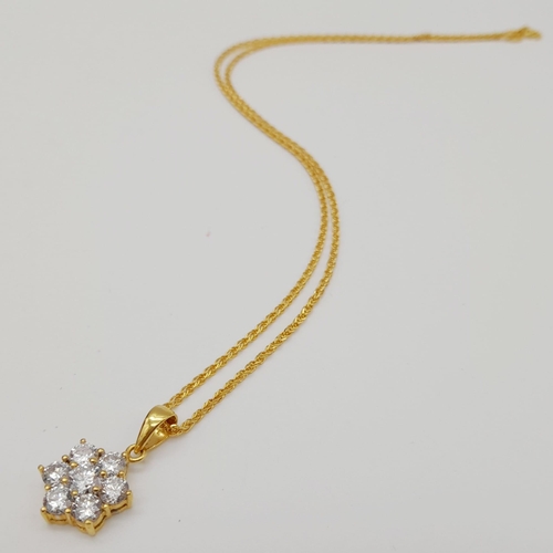 75 - An 18K Yellow Gold Floral Decorative Diamond Jewellery Set.
A necklace with pendant, ring and a pair... 