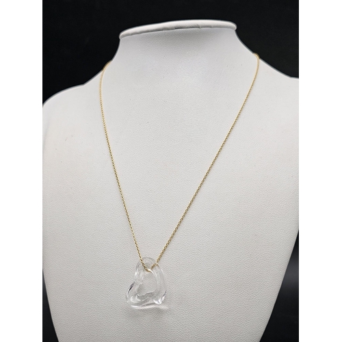 103 - A Tiffany and Co. 18K Gold Necklace with a Tiffany Open Heart Crystal Pendant. 2.5cm and 42cm. 4.4g ... 